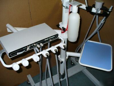 Two dental dynamics 3 handpiece controls on folding arm