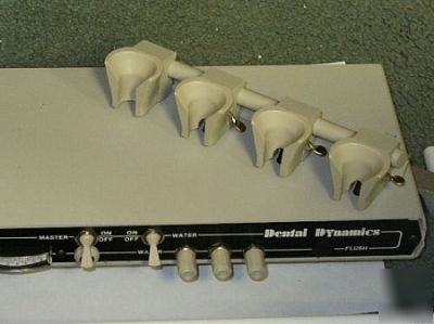 Two dental dynamics 3 handpiece controls on folding arm