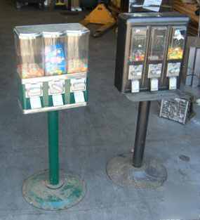 2 coin operated candy vending machines on stands